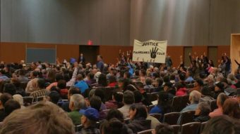 Protestors shouts out in support of the Fairbanks Four during Gov Bill Walker's address to the Alaska Federation of Natives convention. (Photo by Jennifer Canfield/KTOO)