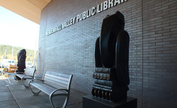The main entry features bronze sculptures of Eagle and Raven bibliophiles by Dan DeRoux. (Photo by Matt Miller/KTOO)