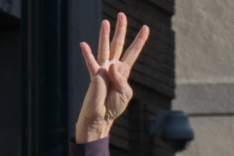 Protesters at the Capitol in Juneau raised four fingers in support of the Fairbanks 4 on Oct. 24, 2015.