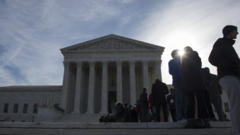 People wait in line outside the Supreme Court in March. There is a public line and a separate line reserved for members of the Supreme Court bar. Molly Riley/AP