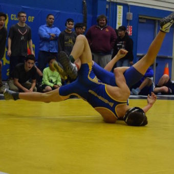 Bethel Warrior Thomas Dyment facing off against a wrestler from Nome at BRHS. (Photo Courtesy of Hugh Dyment)