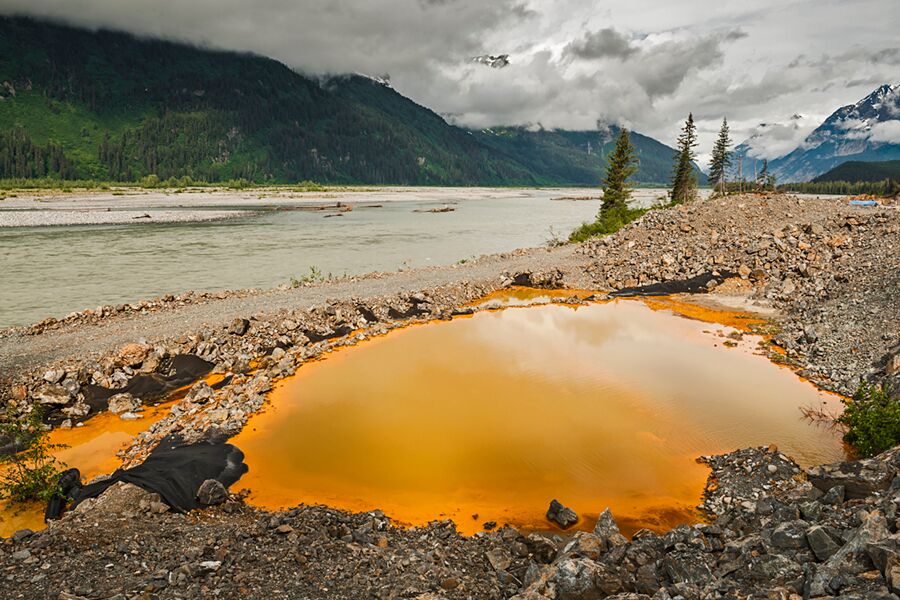 Acid drainage from the Tulsequah Chief Mine, discolors a leaking containment pond next to the Tulsequah River in British Columbia in 2013. (Photo Courtesy Chris Miller/Trout Unlimited)