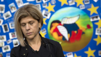 Tima Kurdi, seen here next to a painting of her late nephew, Alan Kurdi, says she has received official approval to welcome her brother and his family into her home in Canada. Virginia Mayo/AP