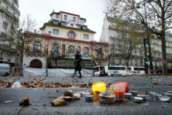 A woman walks past the Bataclan theater in Paris on Tuesday. At least 82 people were killed in the theater during coordinated attacks on Friday. (Photo by Patrick Kovarik /AFP/Getty Images)