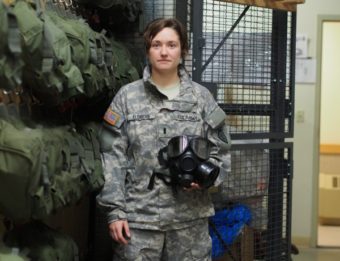 1st Lt. Elizabeth Eldridge holds an M40 Protective Mask inside the NBC Cage at JBER. (Photo by Zachariah Hughes/KSKA)