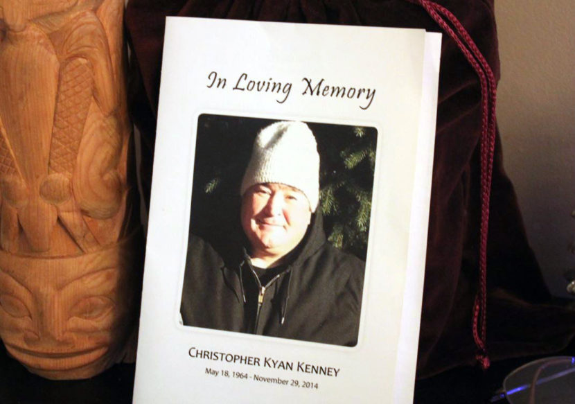 Chris Kenney's ashes sit next to one of his wood carvings on a table stand in his brother Rob Kenney's house. (Photo by Lisa Phu/KTOO)