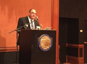 Commission Chair Greg Razo talks about the new report at the Captain Cook Hotel. (Photo by Anne Hillman/KSKA)
