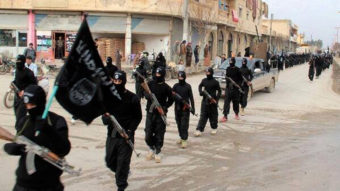 This undated file image posted on a militant website on Jan. 14, 2014, shows fighters from the Islamic State of Iraq and the Levant (ISIL) marching in Raqqa, Syria. Uncredited/AP
