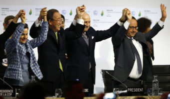 French President Francois Hollande, right, French Foreign Minister and president of the COP21 meetings Laurent Fabius, second right, UN climate chief Christiana Figueres, left, and UN Secretary-General Ban ki-Moon join hands after the final adoption of an agreement at the COP21 United Nations conference on climate change. Francois Mori/AP