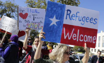 Members of The Syrian People Solidarity Group protest on Nov. 22 in Austin, Texas, after Texas Gov. Greg Abbott announced he'd refuse to allow Syrian refugees in the state. Texas and the U.S. government are now clashing in court over the issue. Erich Schlegel/Getty Images