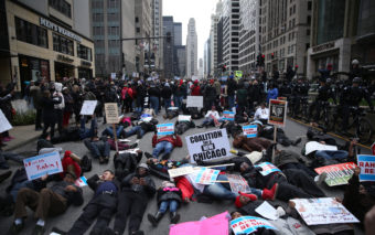 People participate in what organizers are calling a "Black Christmas" protest on Michigan Avenue in downtown Chicago Thursday. E. Jason Wambsgans/Chicago Tribune/TNS via Getty Images