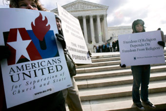 Activists hold posters during a March 2005 rally in front of the U.S. Supreme Court to support separation of church and state. The court heard two cases regarding whether Ten Commandments monuments should be displayed on government properties. Alex Wong/Getty Images