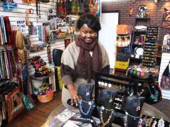 Louise Sano sells jewelry, clothing and gifts at her boutique, Global Villages, on Buffalo's west side. "It's very easy to integrate as a new American, a new person coming to the U.S. So I feel like I have created my own village," she says. Joel Rose/NPR