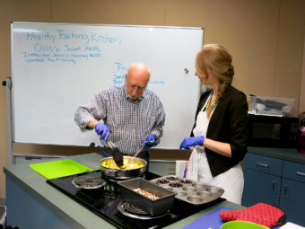 Ray Spaulding cooks apples in front of a class on cooking healthful desserts at the Portland VA withJessica Mooney, right, a clinical dietitian. About 80 percent of veterans are overweight and obese and another quarter have diabetes, according to the Department of Veterans Affairs. Conrad Wilson/OPB