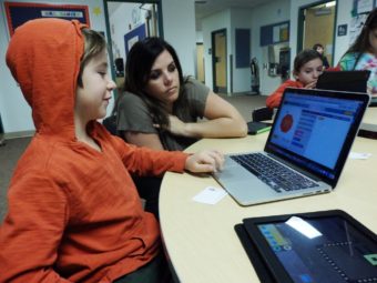 Second grader Nolan Wald learns coding with technology coordinator Sara Hadad. (Photo by Emily Files/KHNS)