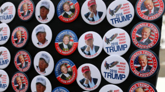 Donald Trump has broken all of the rules of campaigning in New Hampshire but still leads the polls there. A vendor sells Trump buttons at a rally in Concord this month. Allegra Boverman/NHPR