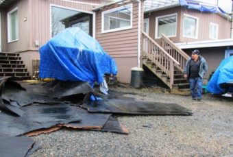 Roofing material is seen in the yard in front of Frank and Marge James’ rented home off North Tongass Highway. The roof blew off in the storm earlier this week. (Photo by Leila Kheiry/KRBD)