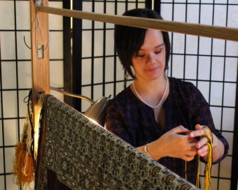Keeping with tradition, Lily Hope covers her weaving. She won't publicly share photos until the blanket is finished. (Photo by Elizabeth Jenkins/KTOO)