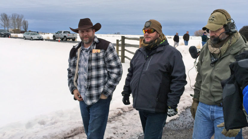 Ammon Bundy, left, approaches an FBI gate at the Burns Municipal Airport in Oregon on Friday. Bundy, the leader of an armed group occupying a national wildlife refuge to protest federal land policies, was among seven arrested on Tuesday. An eighth member of the group was killed. Keith Ridler/AP