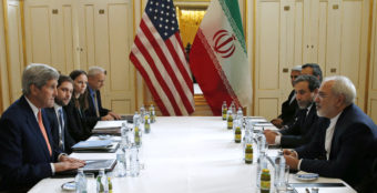 U.S. Secretary of State John Kerry (left) meets with Iranian Foreign Minister Mohammad Javad Zarif (right) in Vienna on Saturday. The International Atomic Energy Agency, or IAEA, has verified that Iran has met all conditions under the nuclear deal. Kevin Lamarque/AP