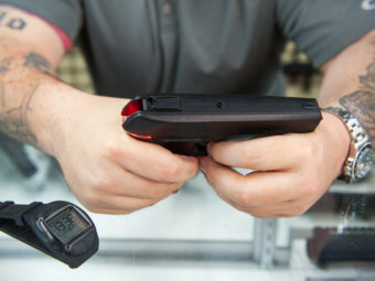 Andy Raymond demonstrates the Armatix iP1, a .22-caliber smart gun that has a safety interlock, at Engage Armaments in Rockville, Md., last year. Katherine Frey/The Washington Post/Getty Images