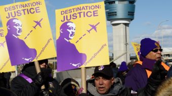 Airport workers rallied Monday for higher wages near LaGuardia Airport in New York City. Don Emmert/AFP/Getty Images