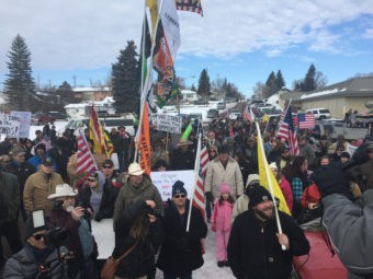 Protesters in Burns, Ore., march toward the home of Dwight Hammond, a local rancher convicted of arson on federal land. The Jan. 2 protest was peaceful, but ended with a group of militiamen occupying the Malheur National Wildlife Refuge. Amelia Templeton/OPB