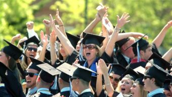 University of New Hampshire graduates cheer at commencement. Tuition at public universities like UNH has risen beyond the reach of many middle-class families. AP