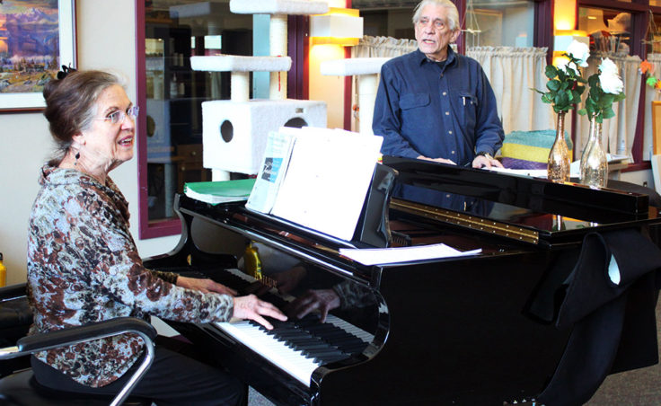 Jacque Farnsworth and Jack Brandt lead a music activity at the Juneau Pioneers’ Home. Farnsworth says she’s been singing and playing piano there since 2003. (Photo by Lisa Phu/KTOO)