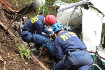 NTSB investigators Brice Banning and Clint Crookshanks on scene near Ketchikan examining the wreckage of a sightseeing plane that crashed in Alaska on June 25, 2015. This is not one of the crashes in the series. (Creative Commons photo by National Transportation Safety Board)