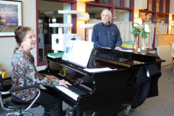 Jacque Farnsworth and Jack Brandt lead a music activity at the Juneau Pioneers' Home. Farnsworth says she's been singing and playing piano there since 2003. (Photo by Lisa Phu/KTOO)