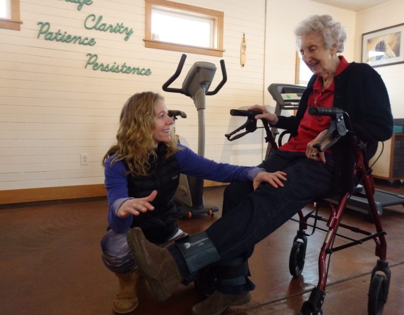 Haines physical therapist Marnie Hartman works with 92-year-old patient Marge Ward. Hartman says most of her business comes from people 65 and older. (Photo by Emily Files/KHNS)