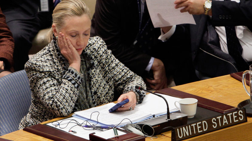 Hillary Clinton, then secretary of state, checks her cellphone after her address at a United Nations meeting in 2012. (Richard Drew/AP)