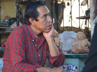 Guatemalan woodcarver Nicolas Chavez creates traditional Mayan figures at his rooftop workshop and sells them on Novica's website. (Laura Sydell/NPR)