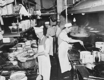 Chefs at work in the kitchen of a restaurant in New York's Chinatown, circa 1940. For many Chinese, opening up restaurants became a way to bypass U.S. immigration laws designed to keep them out of the country. Weegee(Arthur Fellig)/International Center of Photography/Getty Images