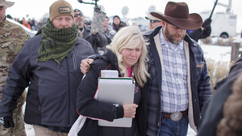 Shawna Cox, seen here walking with Ammon Bundy and other armed anti-government protesters at the Malheur National Wildlife Refuge near Burns, Ore., last month, cites "extremely serious public corruption" in a countersuit. Both Cox and Bundy face federal charges. Rob Kerr/AFP/Getty Images
