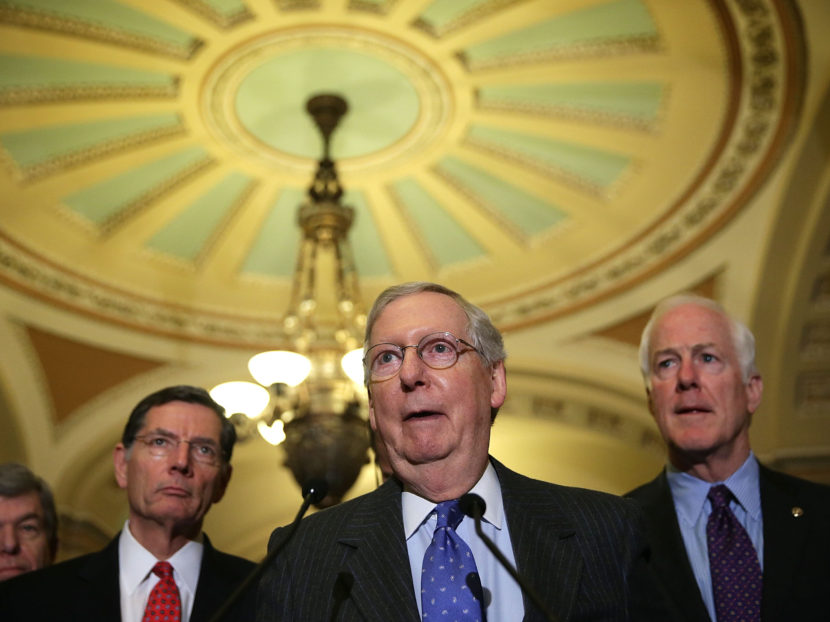 Senate Majority Leader Mitch McConnell (center), R-Ky., speaks to members of the media as fellow Republican Sen. John Barrasso of Wyoming (left) and Senate Majority Whip John Cornyn of Texas (right) listen after the Republican weekly policy luncheon on Jan. 20. (Alex Wong/Getty Images)