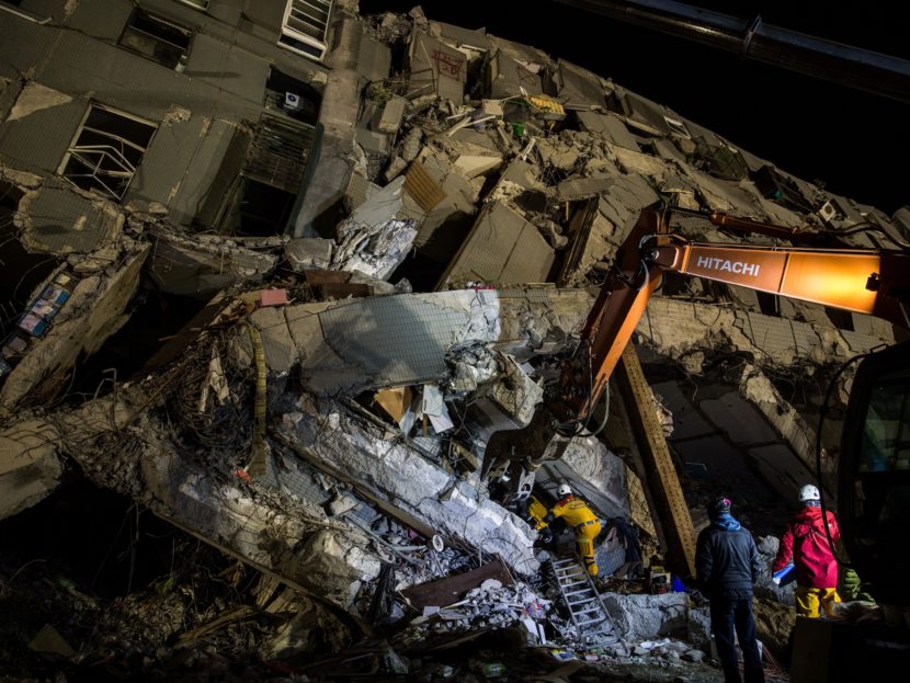 Rescue workers look for survivors in the remains of a building which collapsed in the 6.4 magnitude earthquake, in the southern Taiwanese city of Tainan. (Anthony Wallace/AFP/Getty Images)