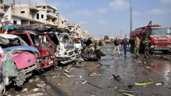 Damaged vehicles are seen at the site of a double car bomb attack in the Zahraa neighborhood of Homs in central Syria. The city is almost completely controlled by the Syrian government, and has regularly been targeted by attacks. AFP/Getty Images