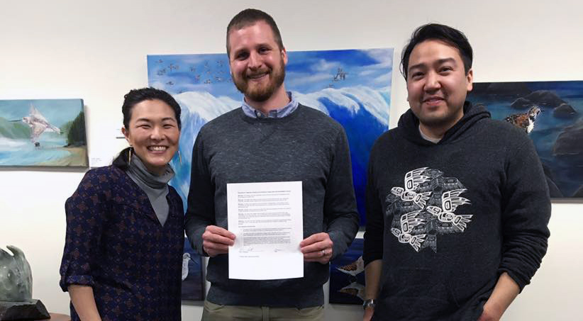 Juneau Arts and Humanities Council board members Christy NaMee Eriksen, Eric Scott and Rico Worl (l-r) pose for a photo after signing a resolution to bring more diversity to the council's activities. (Photo courtesy of Christy NaMee Eriksen)