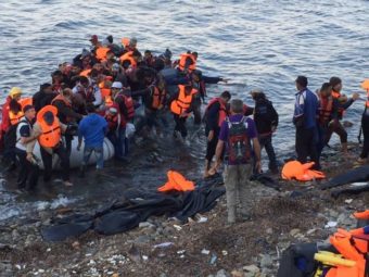 A raft filled with refugees on the shores of Lesbos. (Photo by Eric Kocher)