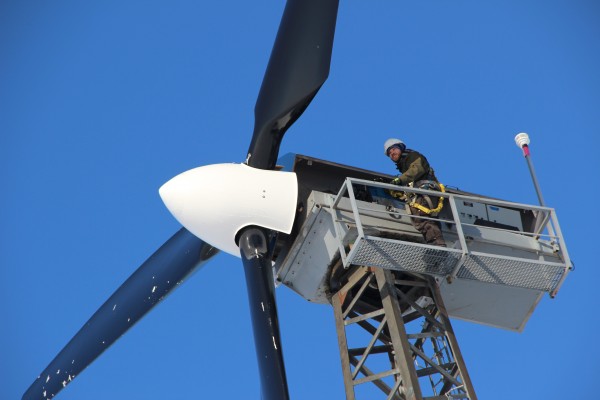 Mike Wassallie climbs a wind turbine in Kwigillingok to check the blades after a blizzard. (Photo by Rachel Waldholz/APRN)