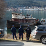 Members of the Coast Guard watch the tug Challenger moving into position to be beached and demolished on March 7, 2016 (Photo by David Purdy/KTOO)