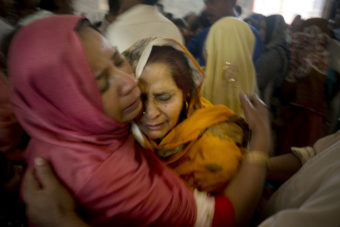 Pakistani Christian women mourn the deaths of their family members during a funeral service at a local church in Lahore, Pakistan, on Monday. B.K. Bangash/AP