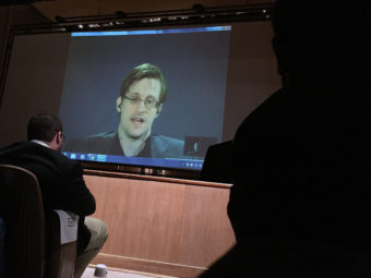 Former National Security Agency contractor Edward Snowden spoke via video conference at the Johns Hopkins University auditorium in Baltimore Feb. 17. Juliet Linderman /AP