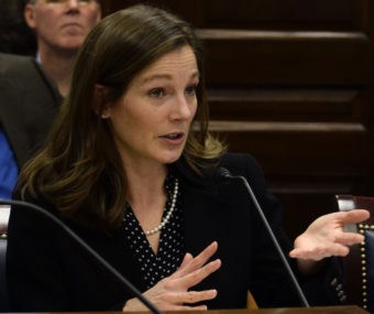 Rena Delbridge, an aide to Rep, Mike Hawker, explains House Bill 132 to the House Resources Committee, March 6, 2015. Hawker and House Speaker Mike Chenault, at her side, are sponsors of the bill. It had upset Gov. Bill Walker when it was introduced earlier in the week because it would limit the Alaska Gasline Development Corporation's powers on the Alaska Stand Alone Pipeline. (Photo by Skip Gray/360 North)