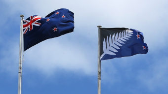 A photo from December shows the current New Zealand flag (left) and the alternative design currently up for a vote. Fiona Goodall/Getty Images News