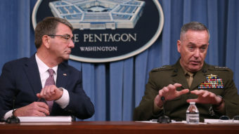 Secretary of Defense Ash Carter (left) says the Pentagon's new hacker program will strengthen America's digital defenses. Carter is seen here with the chairman of the Joint Chiefs of Staff, Gen. Joseph Dunford. Mark Wilson/Getty Images