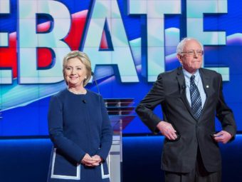 Democratic presidential candidates Hillary Clinton and Bernie Sanders await the start of the Democratic Debate in Flint, Michigan, March 6, 2016. GEOFF ROBINS/AFP/Getty Images