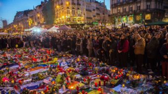 People gather Friday at a makeshift memorial in tribute to the victims of the Brussels terror attacks, on Place de la Bourse square in Brussels. Grieving Belgians held prayers in the rain for the victims, but there was also growing anger at the government for letting a string of militants slip through the net. Laurie Dieffembacq/AFP/Getty Images